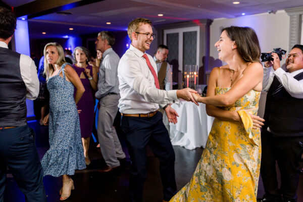 A man and woman dancing at an event.