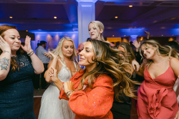A group of people dancing at an event.