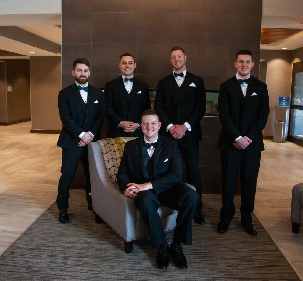 A group of men in suits posing for the camera. A group of men in suits posing for the camera.