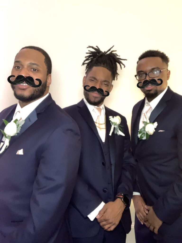 Three men in suits and ties with fake mustaches on their heads. Three men in suits and ties with fake mustaches on their heads.