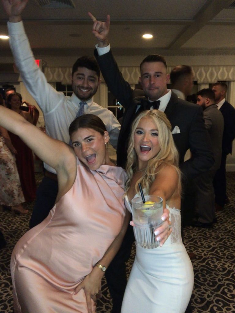 A group of people that are dancing in the room A group of people that are dancing in the room