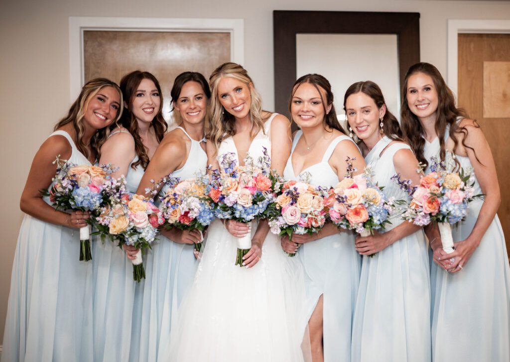 A group of women holding flowers in their hands. A group of women holding flowers in their hands.