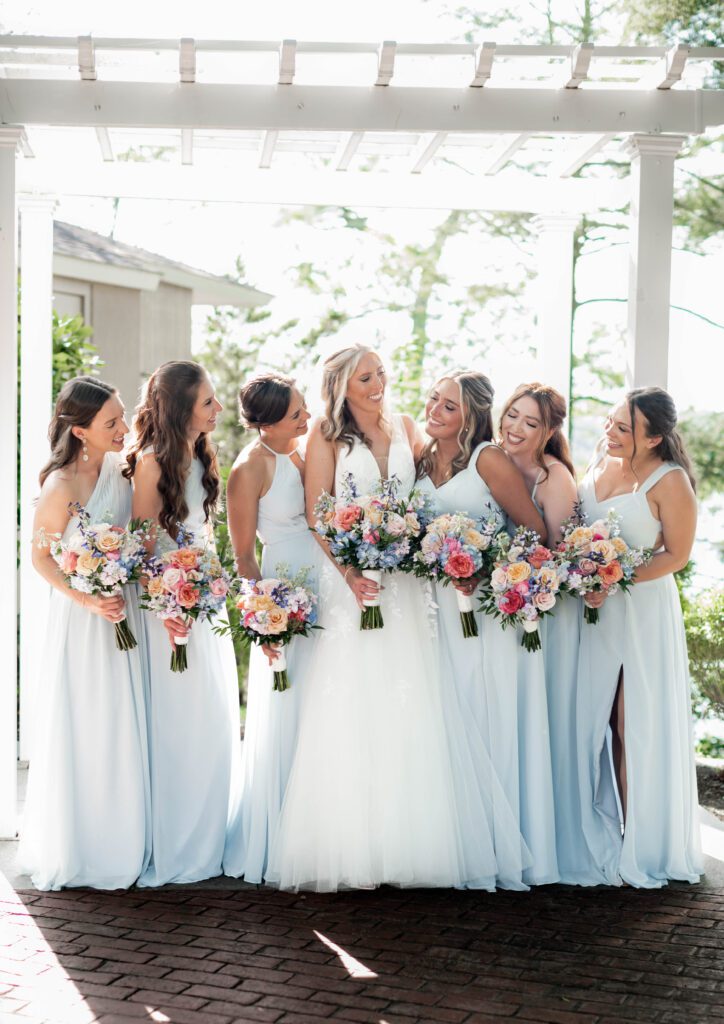 A group of women standing next to each other. A group of women standing next to each other.