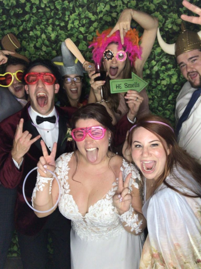 A group of people posing for a photo in front of a wall. A group of people posing for a photo in front of a wall.