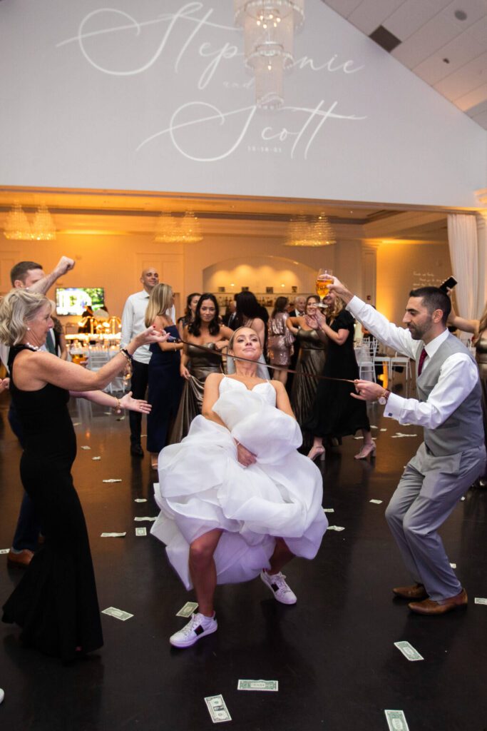 Bride and guests cheer with raised glasses at wedding celebration. Bride and guests cheer with raised glasses at wedding celebration.