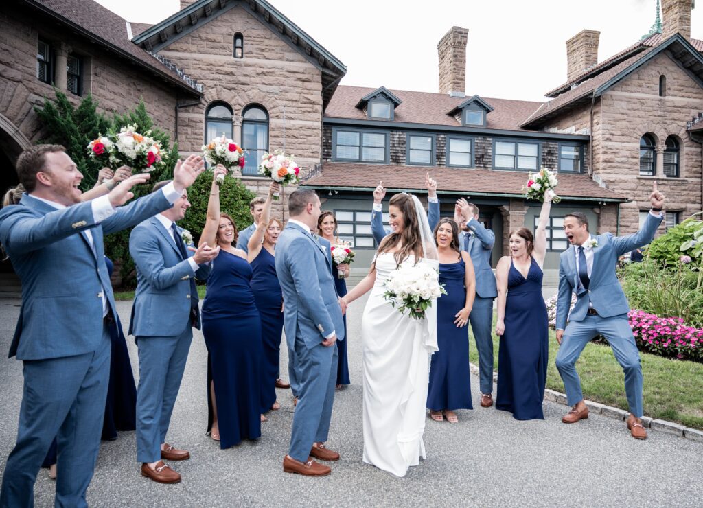 Happy wedding party celebrating outside a historic building. Happy wedding party celebrating outside a historic building.