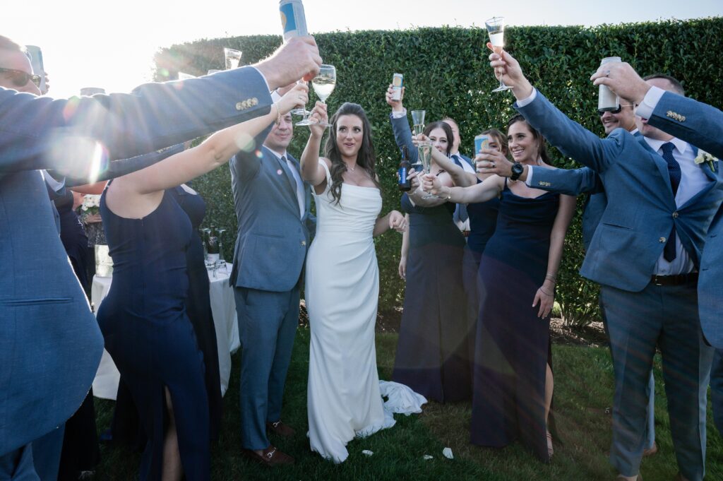 Bride and groom toast with friends in an outdoor celebration. Bride and groom toast with friends in an outdoor celebration.