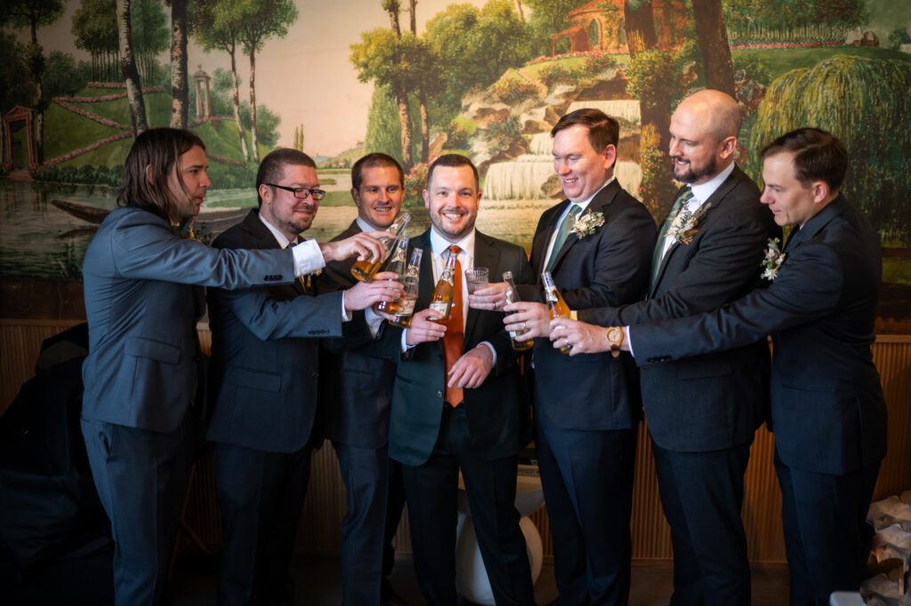 Group of men in suits toasting with drinks at a formal event. Group of men in suits toasting with drinks at a formal event.