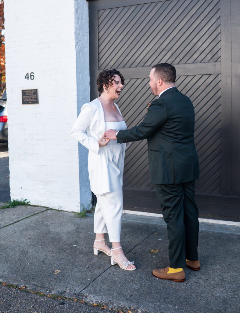 A couple dressed formally, holding hands and smiling outdoors. A couple dressed formally, holding hands and smiling outdoors.