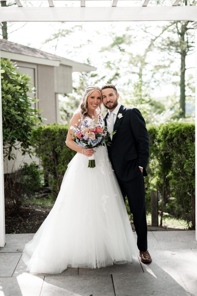 Bride and groom posing together outdoors on their wedding day. Bride and groom posing together outdoors on their wedding day.