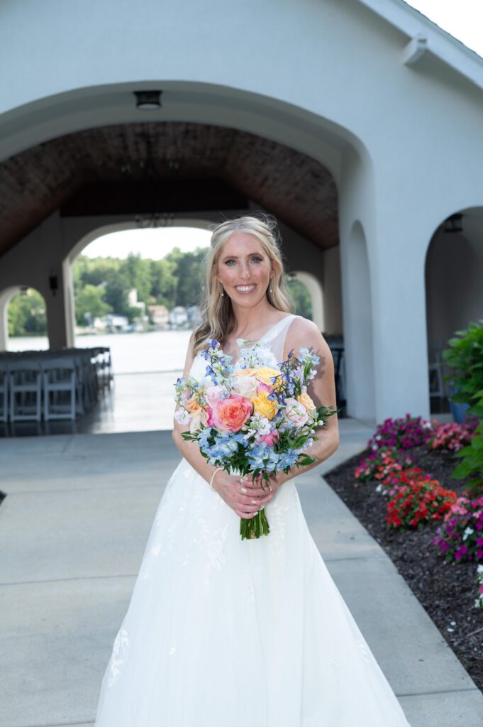 Bride in white dress holding a colorful bouquet outdoors. Bride in white dress holding a colorful bouquet outdoors.