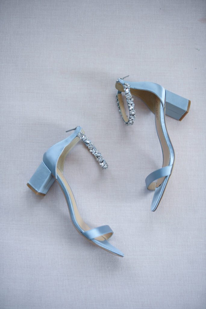 Elegant light blue high-heeled sandals with ankle straps and decorative buckles. Elegant light blue high-heeled sandals with ankle straps and decorative buckles.