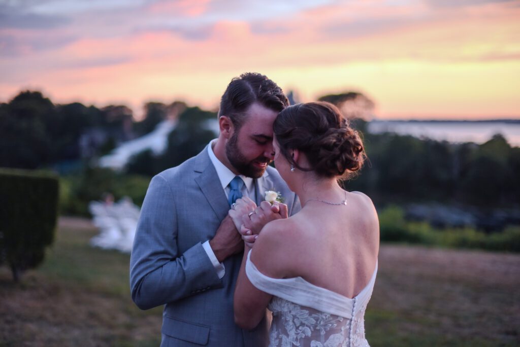 Couple sharing a romantic moment with champagne at sunset outdoors. Couple sharing a romantic moment with champagne at sunset outdoors.