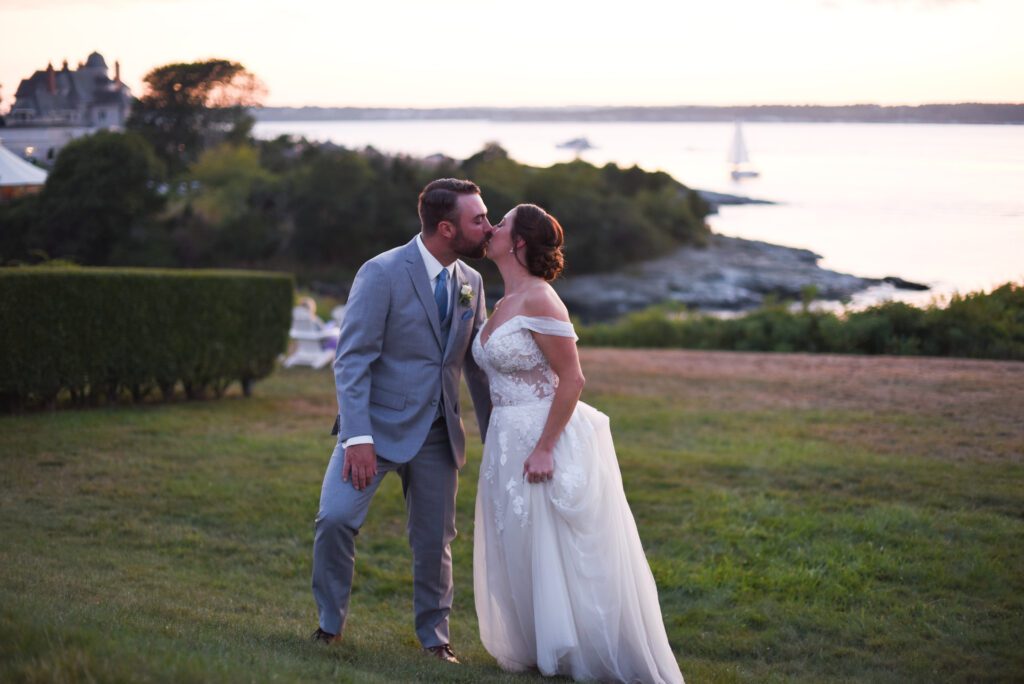 Bride and groom sharing a kiss outdoors at sunset. Bride and groom sharing a kiss outdoors at sunset.