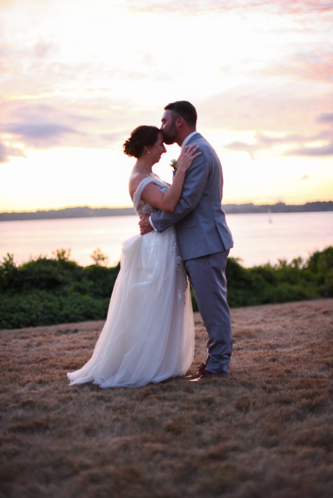 Bride and groom embracing at sunset on a beach. Bride and groom embracing at sunset on a beach.