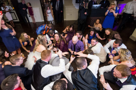 A group of people sitting around each other on the floor.