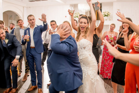A man and woman are dancing in front of other people.