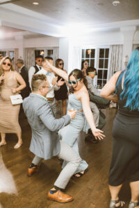 A group of people dancing in the middle of a room.