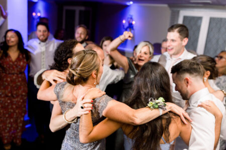 A group of people dancing at a party.