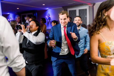 A man in blue jacket holding up two thumbs.