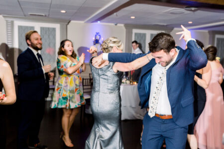 A group of people dancing at a wedding.