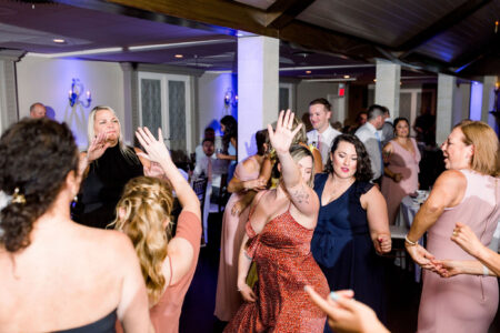 A group of people dancing in the middle of an event.