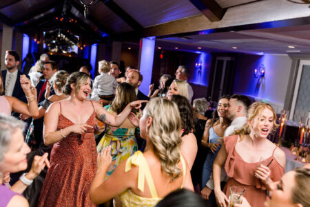 A group of people dancing at an event.