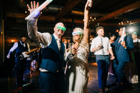 A man and woman are holding up their arms.