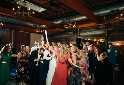 A group of people standing around each other.