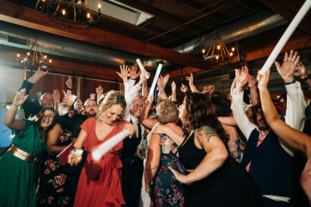 A group of people dancing in the middle of an event.