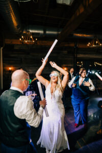 A group of people dancing with some white poles.
