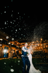 A couple is standing outside under the stars