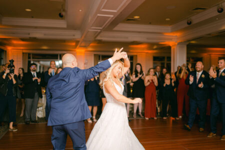 A man and woman dancing in front of an audience.