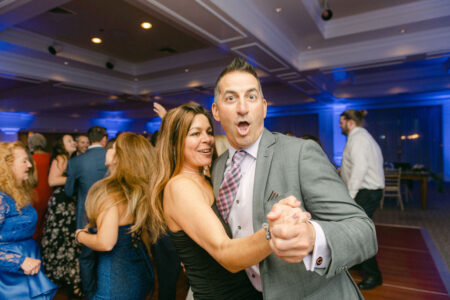 A man and woman dancing at an event.