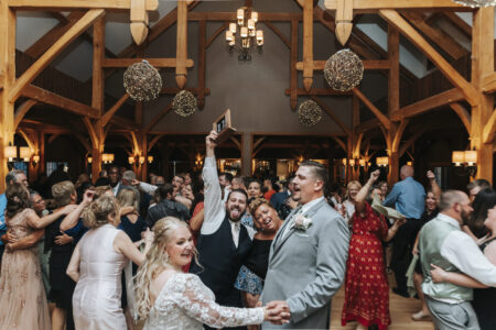 A group of people dancing in the middle of an event.