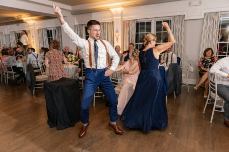 A man and woman dancing in front of other people.