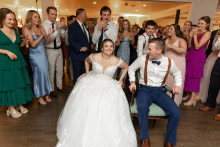 A bride and groom are sitting on the floor