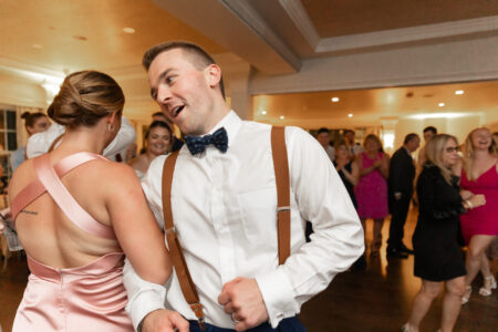 A man in white shirt and brown bow tie