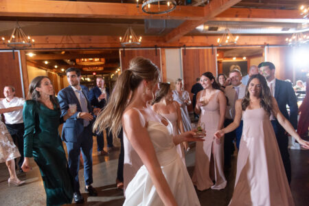 A group of people in formal wear dancing.