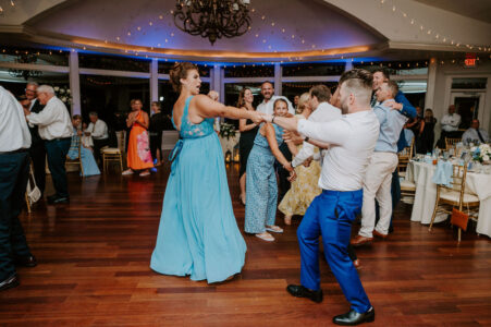 A group of people dancing in a room.