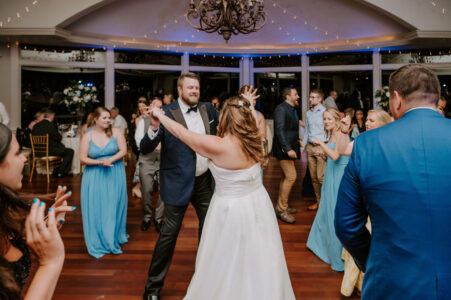 A man and woman dancing in front of other people.