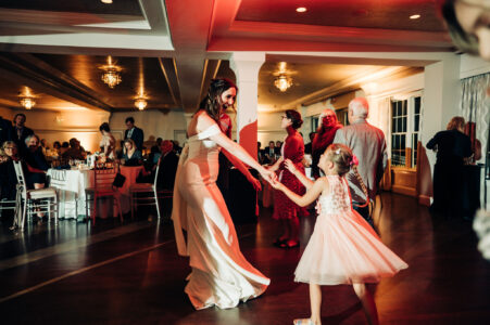 A woman and girl dancing at an event.