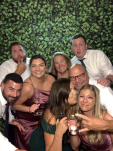 A group of people posing for a picture in front of a wall.