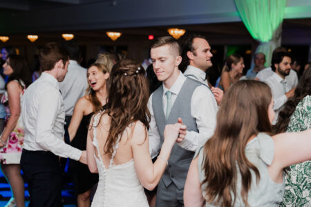 A group of people dancing at a wedding.