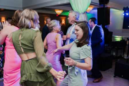 A group of people dancing at an event.