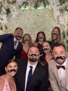 A group of people with fake mustaches on their faces.