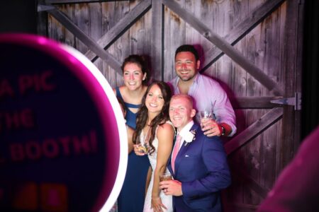 A group of people posing for a photo in front of a mirror.