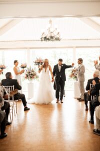 Newlyweds joyfully celebrate their marriage in a bright, elegant ceremony.