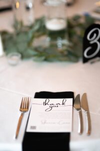 Elegant thank you card at a formal table setting.