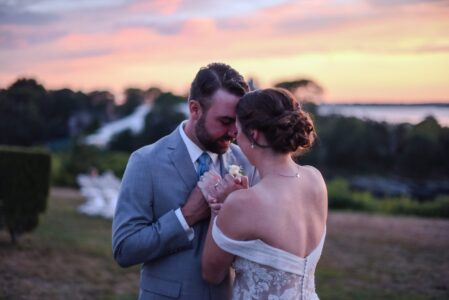 Couple sharing a romantic moment with champagne at sunset outdoors.